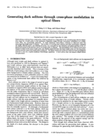 Generating dark solitons through cross-phase modulation in optical fibers