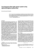 Two-frequency fiber-optic sensor system using high-birefringence optical fiber